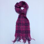 Authentic Burberry pink checkered scarf in soft wool, shown neatly folded with fringes. Luxury fashion at affordable price from abbottbrands on lajimart.com. Ideal for gifting and cold-weather styling.