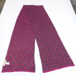 A Michael Kors monogram scarf in magenta and charcoal gray laid flat on a white surface to show the full pattern.