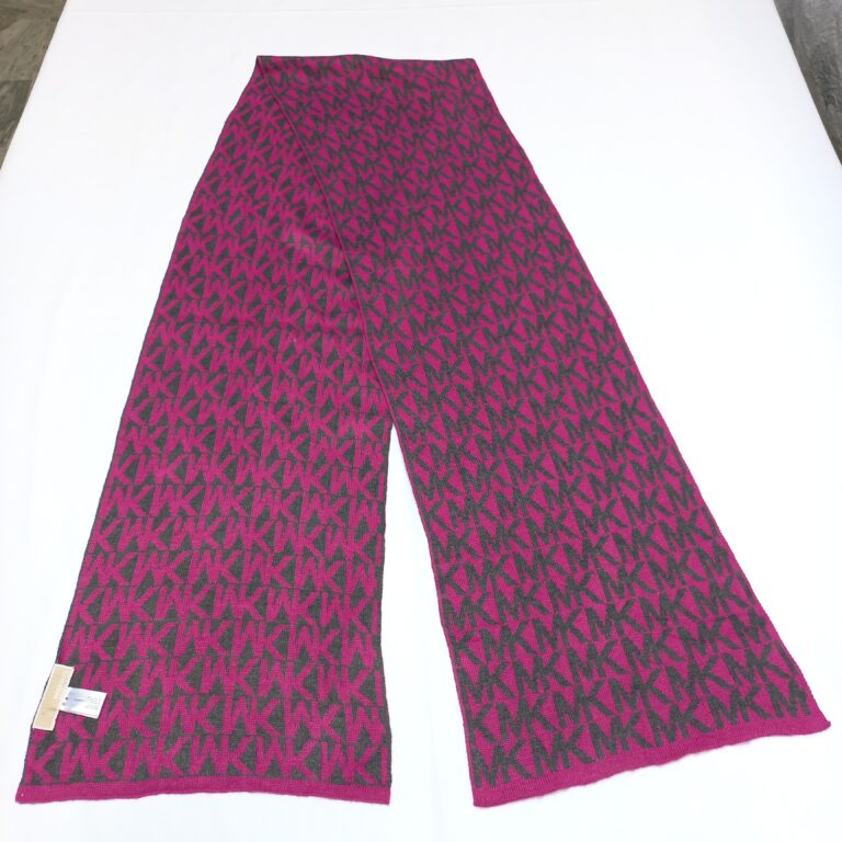 A Michael Kors monogram scarf in magenta and charcoal gray laid flat on a white surface to show the full pattern.